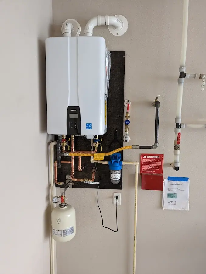 Professional plumber installing copper piping in a Red Oak home